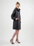 Water-resistant oversized hooded windbreaker rain jacket with multiple pockets and adjustable waist.