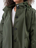 Water-resistant oversized hooded windbreaker rain jacket with multiple pockets and adjustable waist.