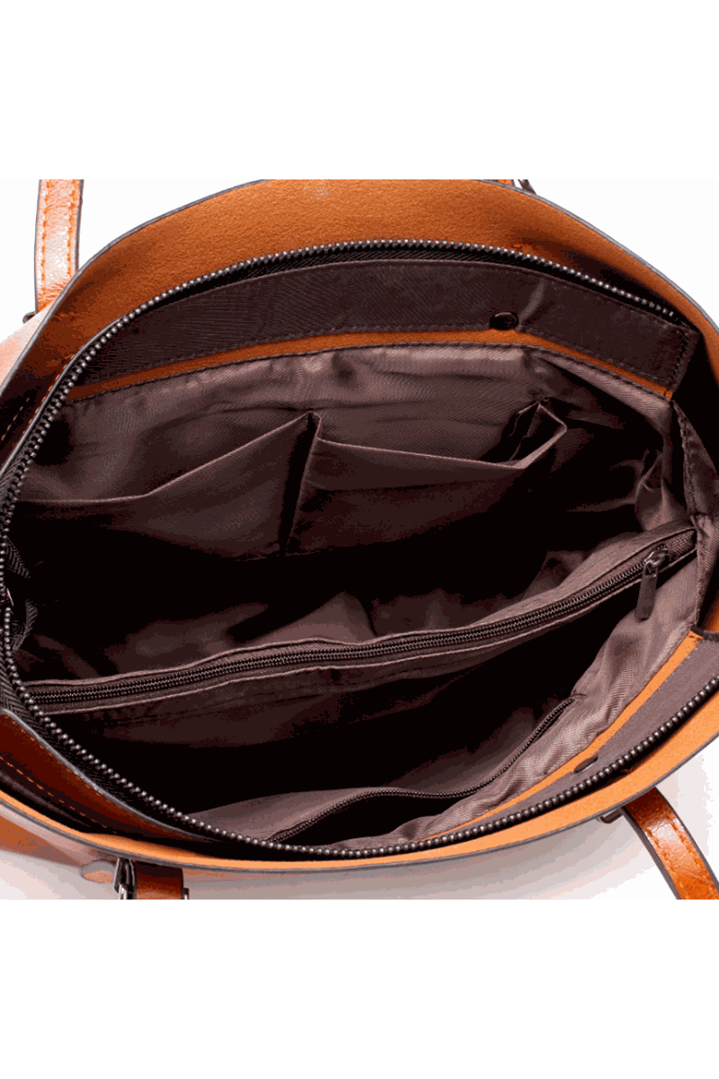 Interior view of a multi strap tote bag showing multiple compartments and brown lining fabric.