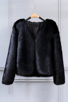 Black bold faux fur luxe jacket with V neckline and button front closure on hanger