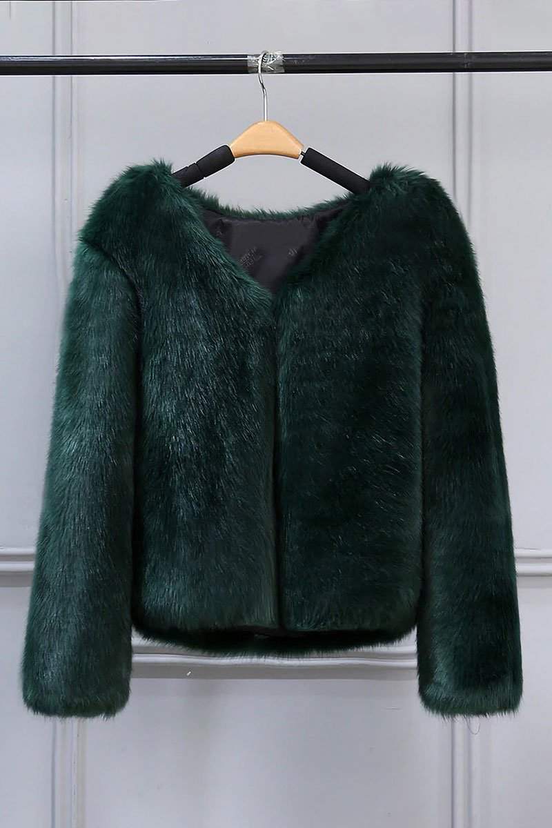 Dark green bold faux fur luxe jacket with V neckline and button closure hanging on wooden hanger